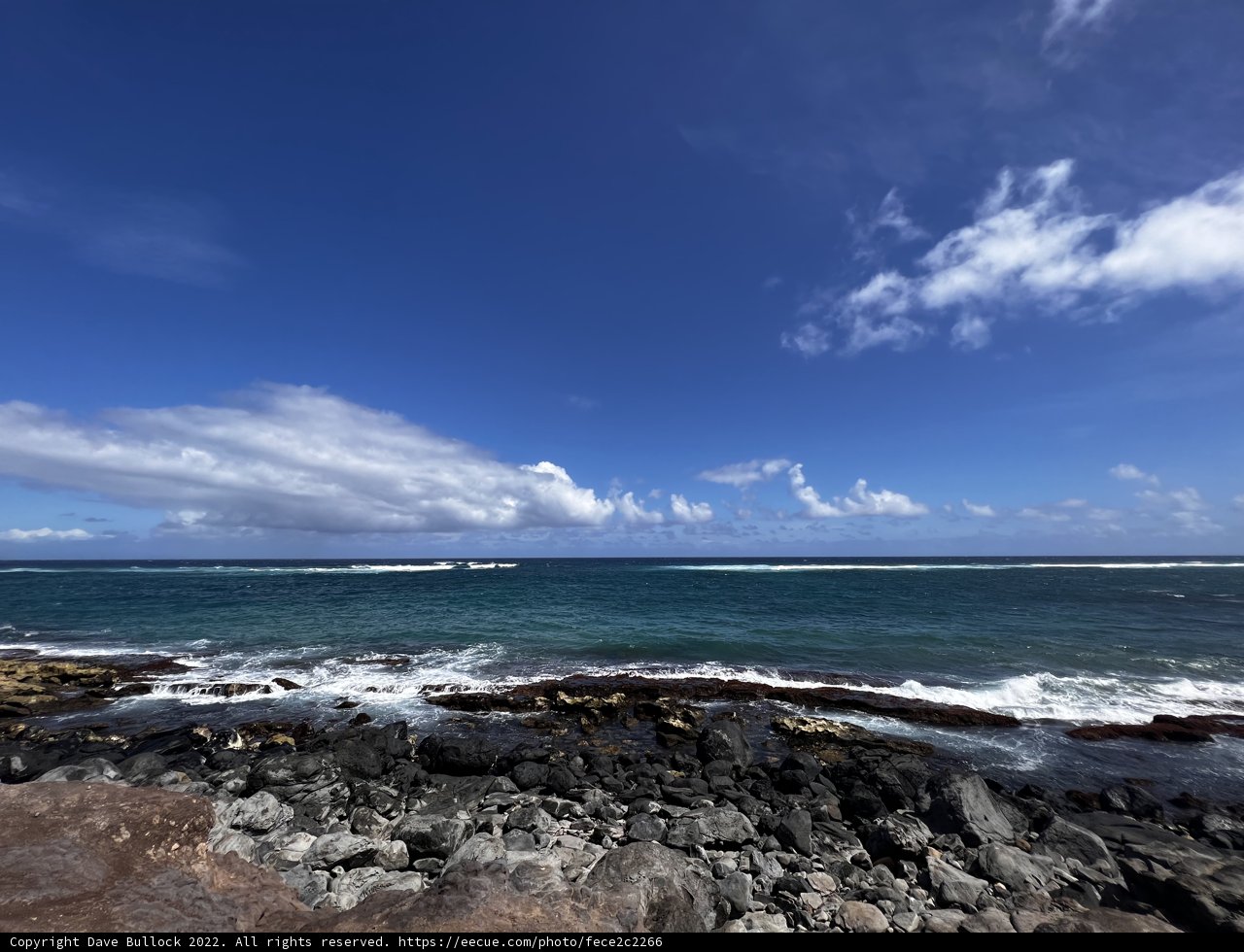 Majestic Waves Crashing Against Rocky Shoreline