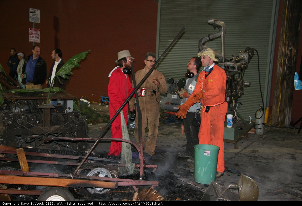 Factory Workers Gather Around Fire