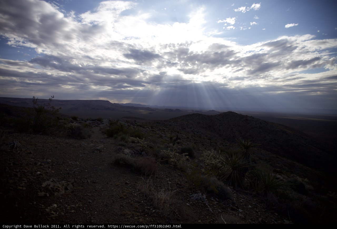 Sunlight Beaming Through Clouds Over a Desolate Desert