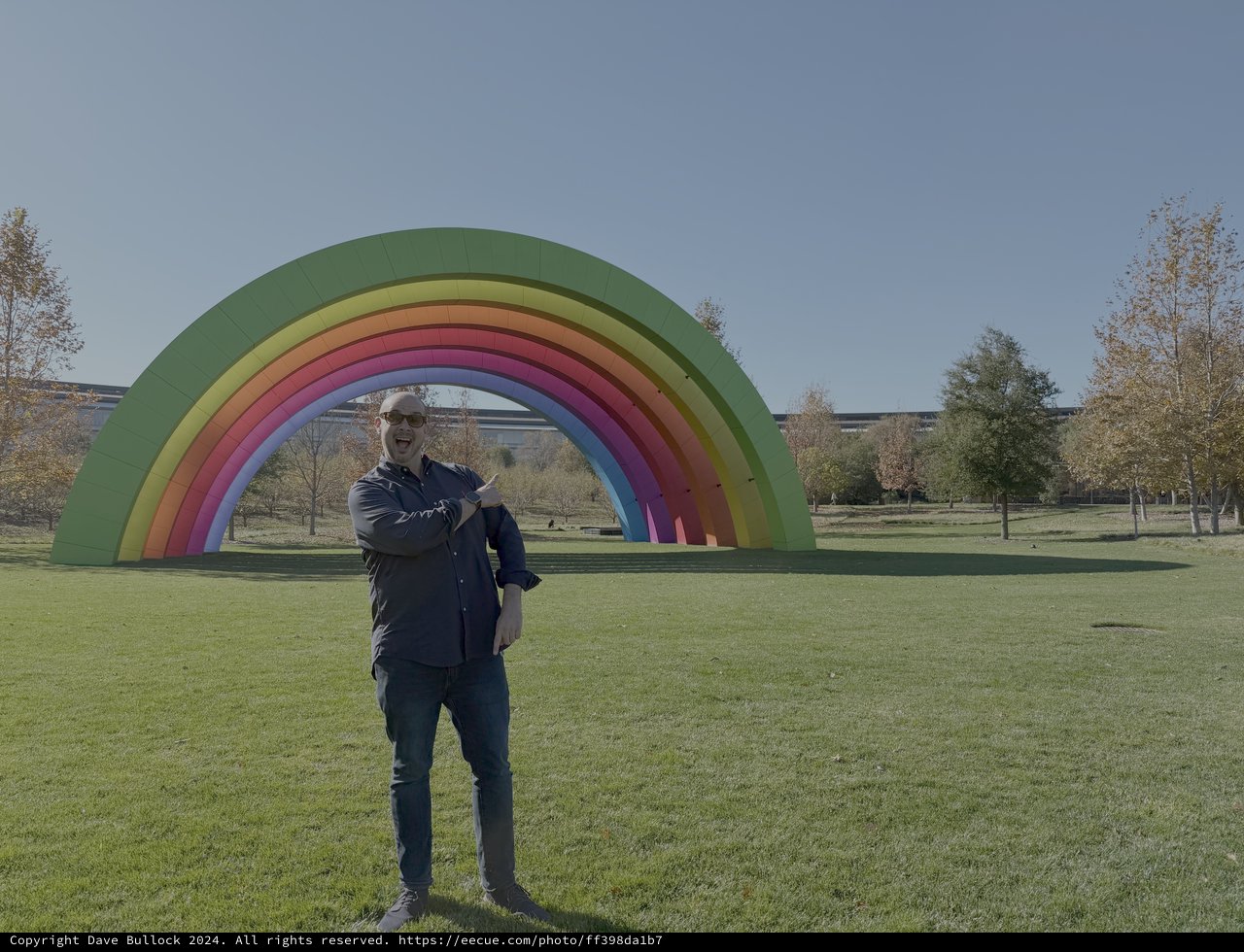 Man Posing at Colorful Rainbow Art Installation