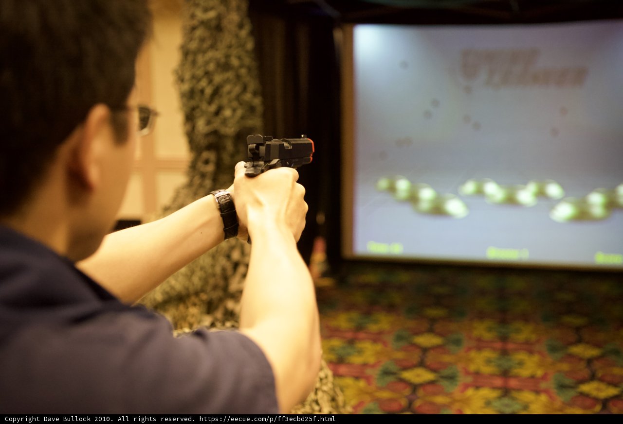 Man with Gun in Front of Screen