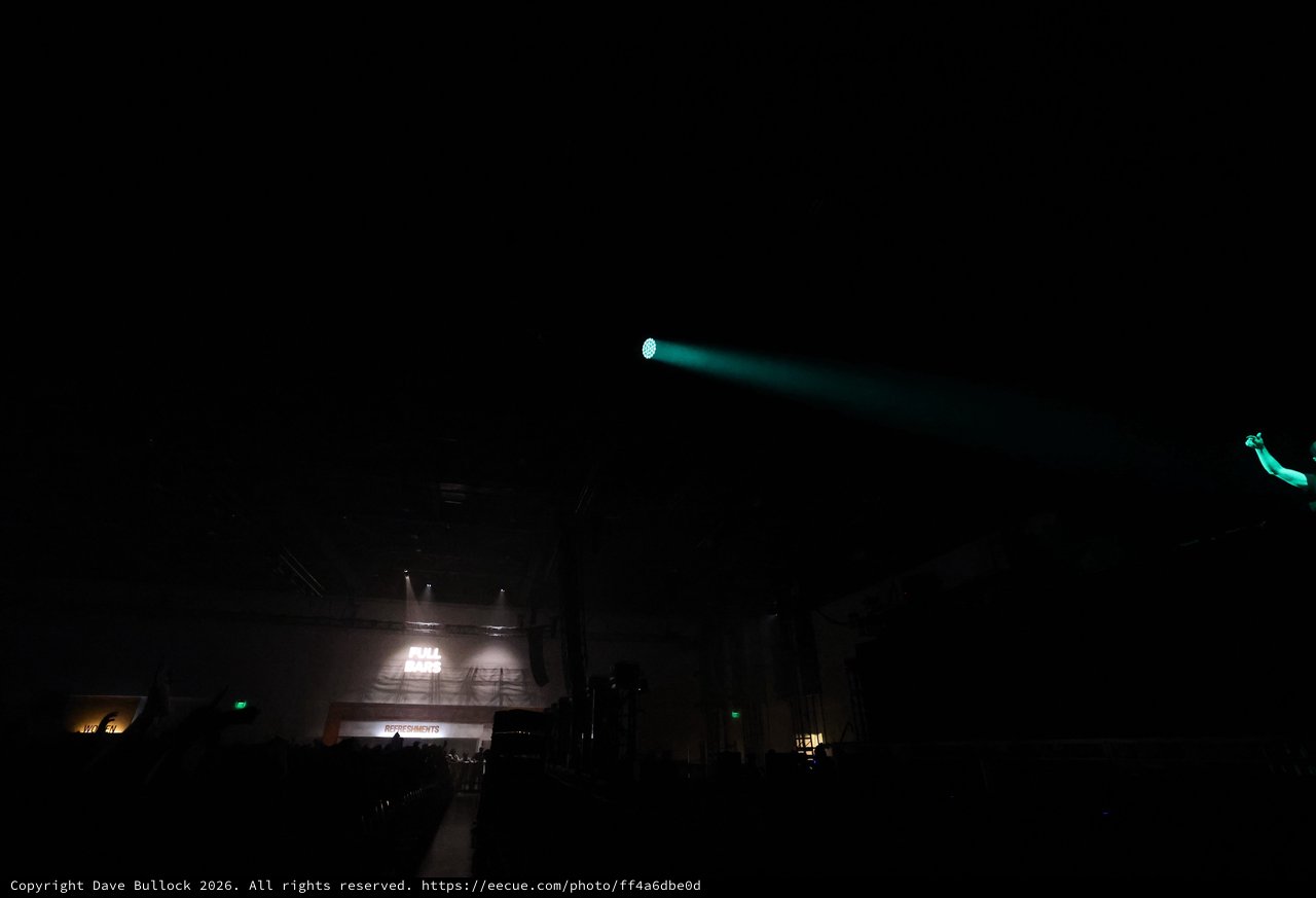 Cyan Laser Beam Cuts Through Dark Festival Night