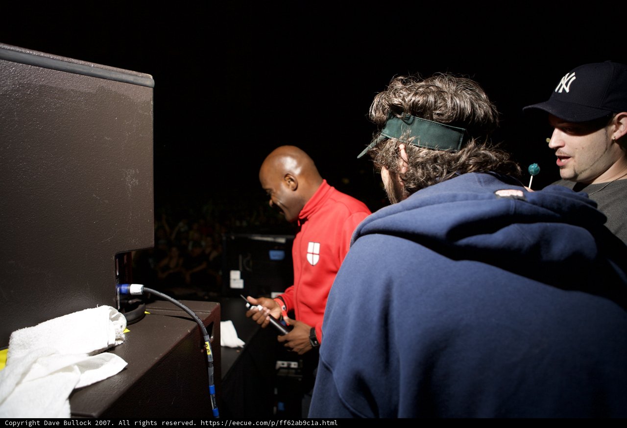 Blue Hoodie Musician Performs with Microphone and Laptop