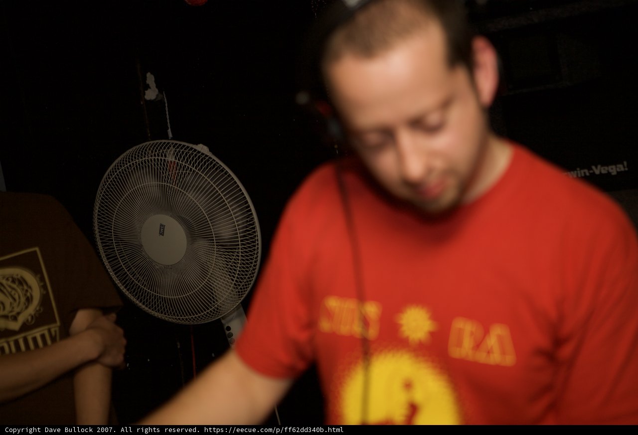 Red-shirted man spinning tunes