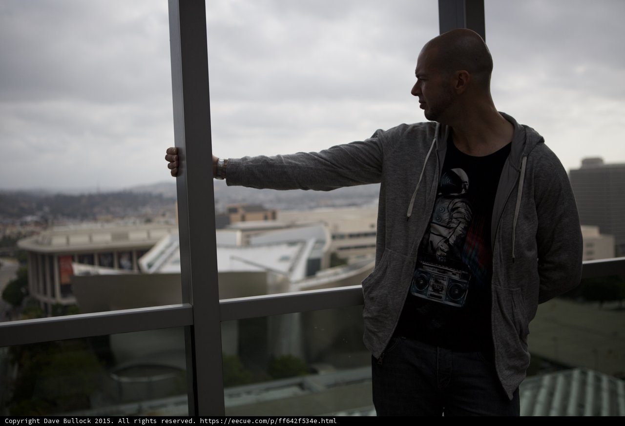 Man Contemplating Cityscape Through Window