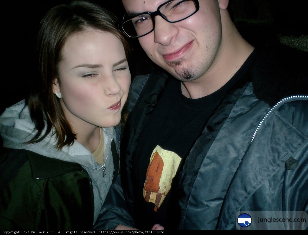 Portrait of Two People in Jackets and Glasses
