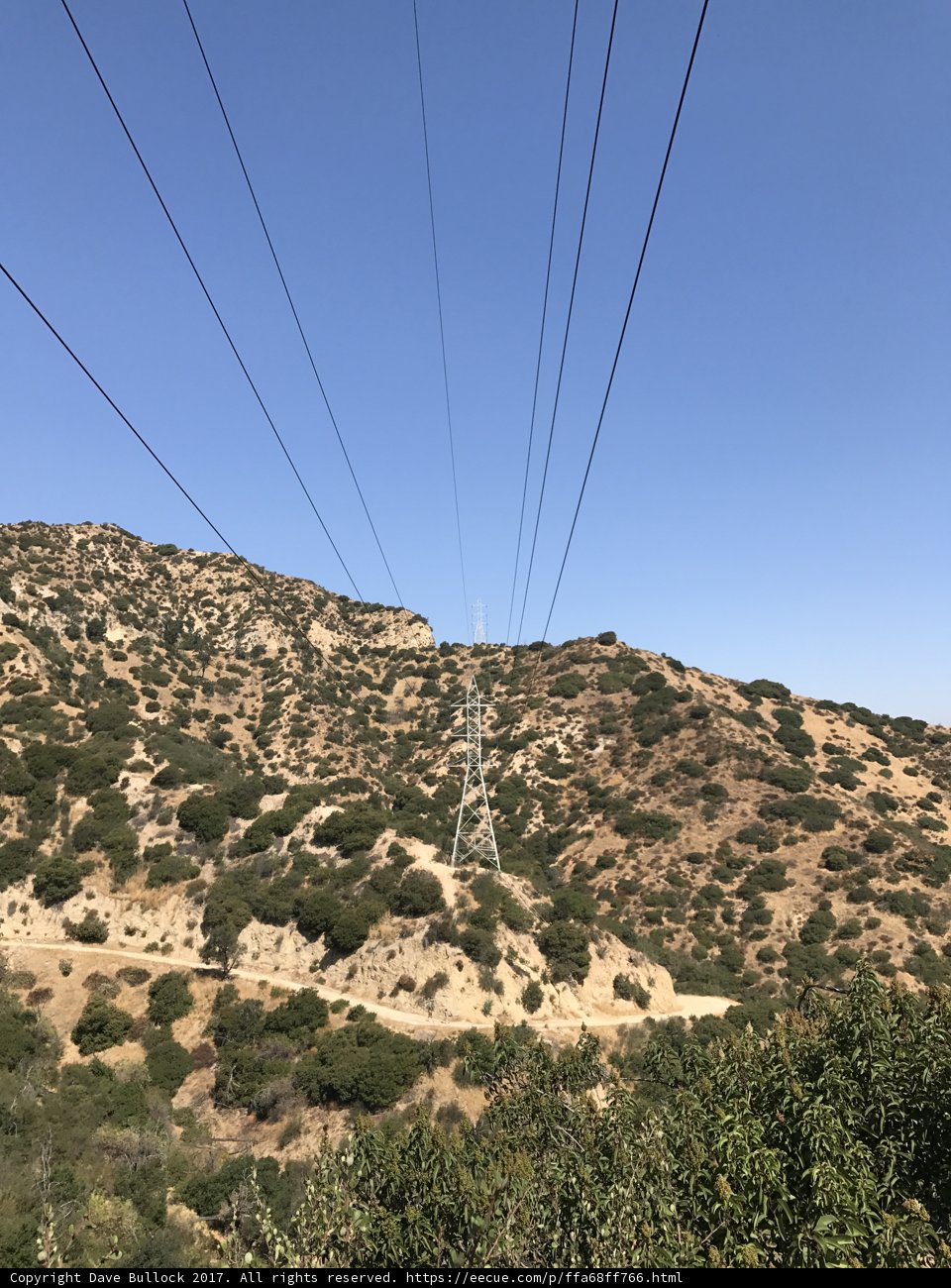 Power lines cutting through the majestic mountains
