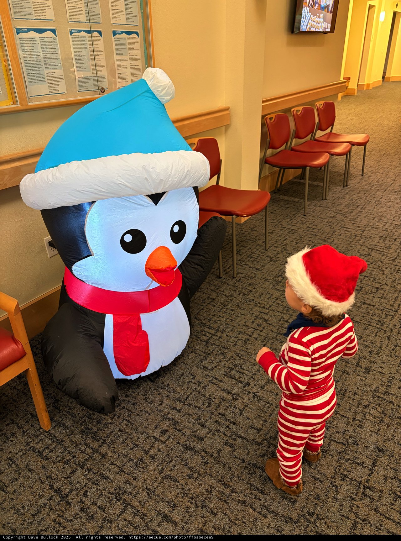 Toddler Meeting Inflatable Snowman at Holiday Event