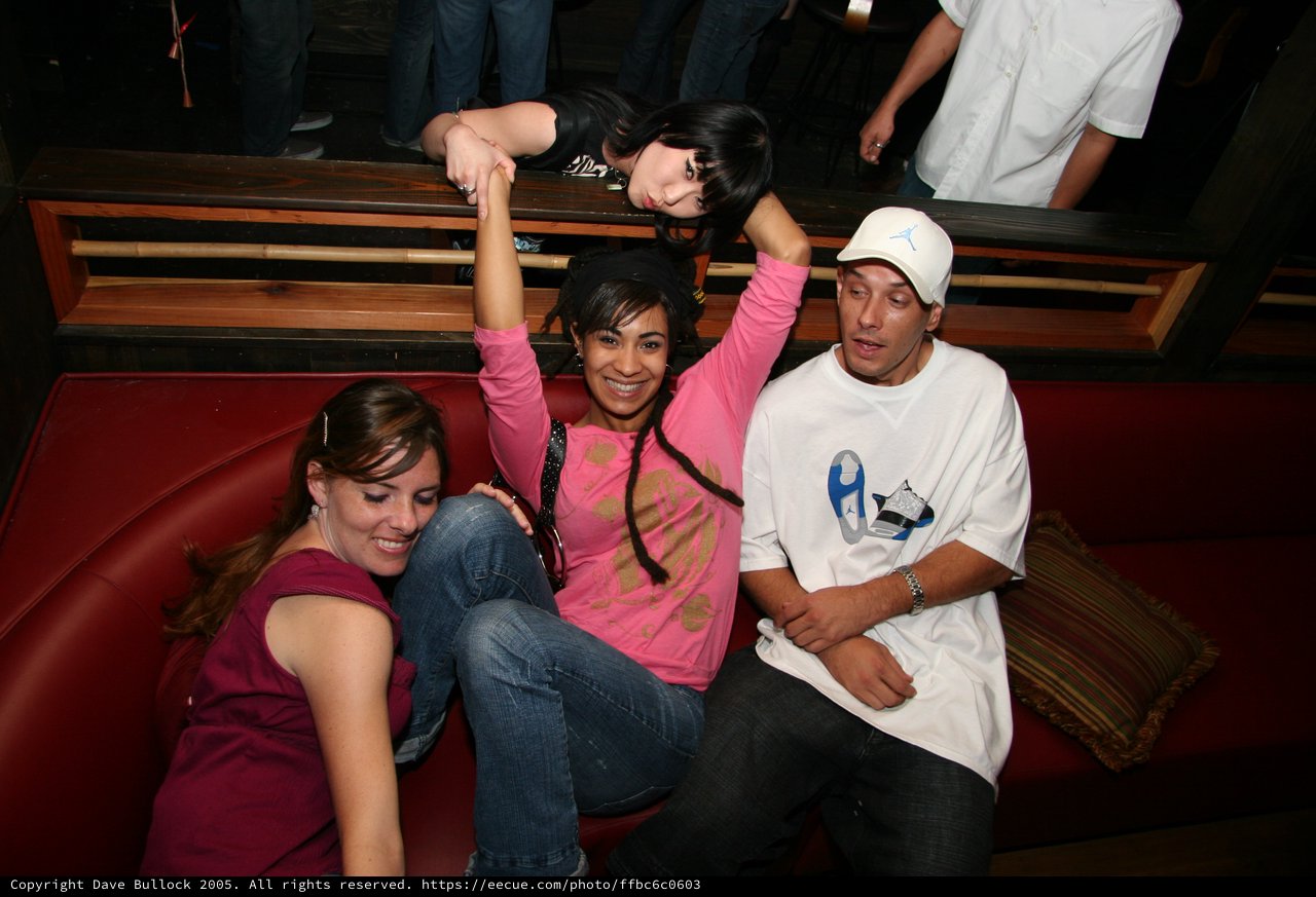 Friends Posing at a Nightclub Booth in 2005