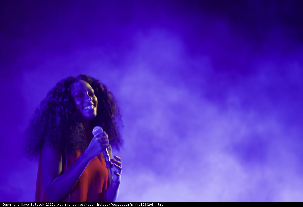 Solange Portrait Smiling Both Hands Microphone Serene Purple