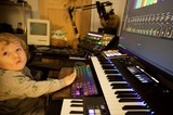 Young Child Explores Music Production Studio Setup