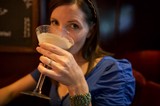 Woman Sipping Cocktail at Upscale Bar