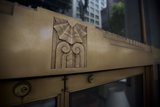 The Intricate Wooden Emblem on the Golden Monastery Door
