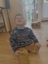 Joyful Child Laughing in Cozy Home Setting