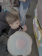 Young Child Enjoying Cotton Candy at Fair