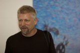Smiling Man in Front of Painting