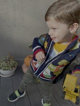 Toddler Playing with Yellow Toy Truck Outdoors