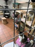 Woman showing love to cat in a cage