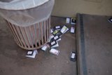 Trash Can Overflowing with Cards