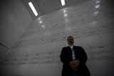 Executive in front of Box Wall