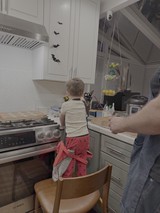Child Cooking in Kitchen with Halloween Decorations