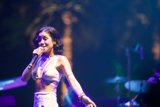 Jhené Aiko Solo Performance Caption: Entertainer Jhené Aiko electrifying the crowd with her powerful voice during a solo performance at Coachella 2014.