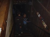 Friends Descending Dimly Lit Venue Staircase at Night