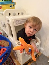 Toddler Playing in White Toy Truck