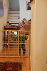 Toddler Behind Safety Gate in Home Interior