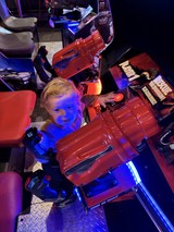 Child Playing Racing Game at Arcade