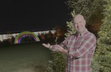 Man Presents Holiday Rainbow Display at Night