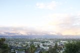 View of Cityscape from Hilltop with Flying Plane