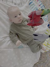 Baby's Playtime on Colorful Patchwork Quilt