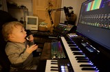 Young Child Explores Music Production Studio Setup