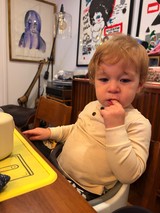 Toddler's Thoughtful Moment in Artistic Living Space