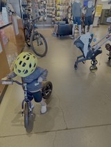 Child on Tricycle in Retail Store