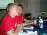 Two Men Work and Drink at Desk
