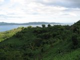 Serene View of Lush Green Hillside and Water Body