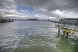 Serene Waterfront Pier with Breathtaking Bridge View