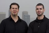 Two Happy Men Standing in Front of a Skyscraper