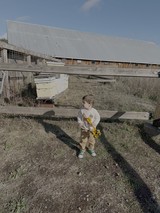 Toddler with Sunflower at Rural Farm
