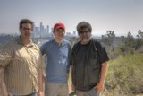 Three Men Enjoying a Sunny Day Outdoors