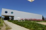 White Office Building with Grassy Front Lawn and Fence