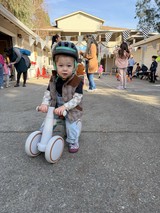 Toddler on Balance Bike at Community Event