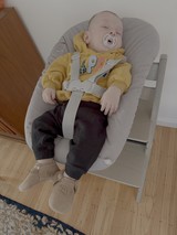Peaceful Baby Napping in Modern High Chair