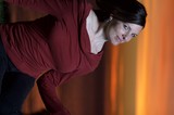 Woman in Red Gazes Skyward at Fiery Sunset