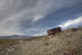 Rusty Water Tank on Rocky Hillside
