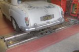 Mechanic working on a white sports car