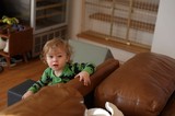 Toddler in Green Dinosaur Pajamas Playing at Home