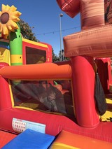 Child Playing in Colorful Inflatable Bounce House